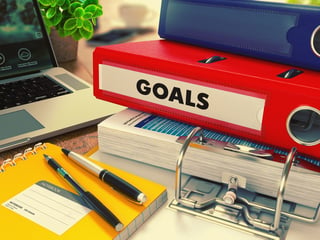 Red Office Folder with Inscription Goals on Office Desktop with Office Supplies and Modern Laptop. Business Concept on Blurred Background. Toned Image..jpeg